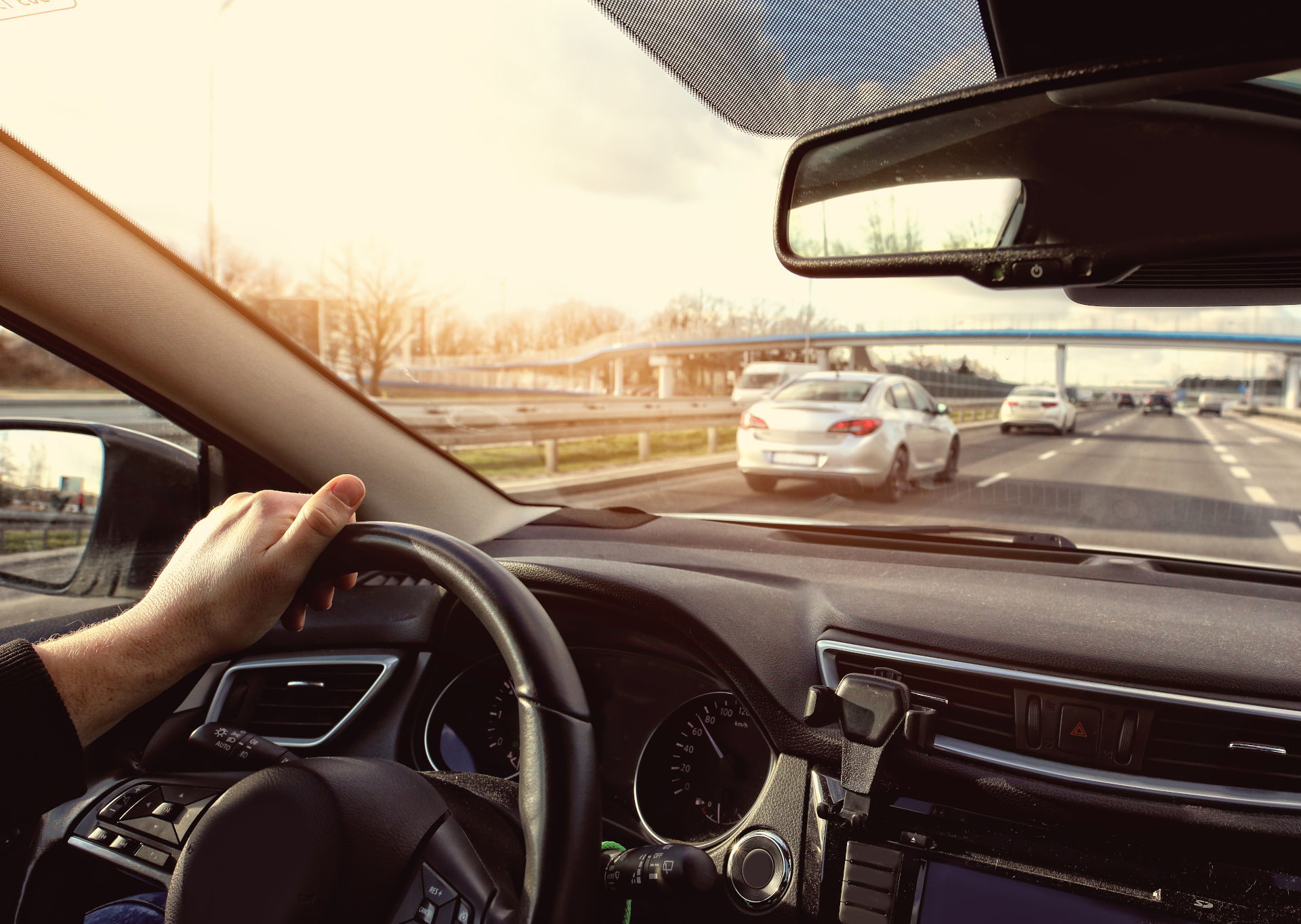 A car driving down a long strait highway